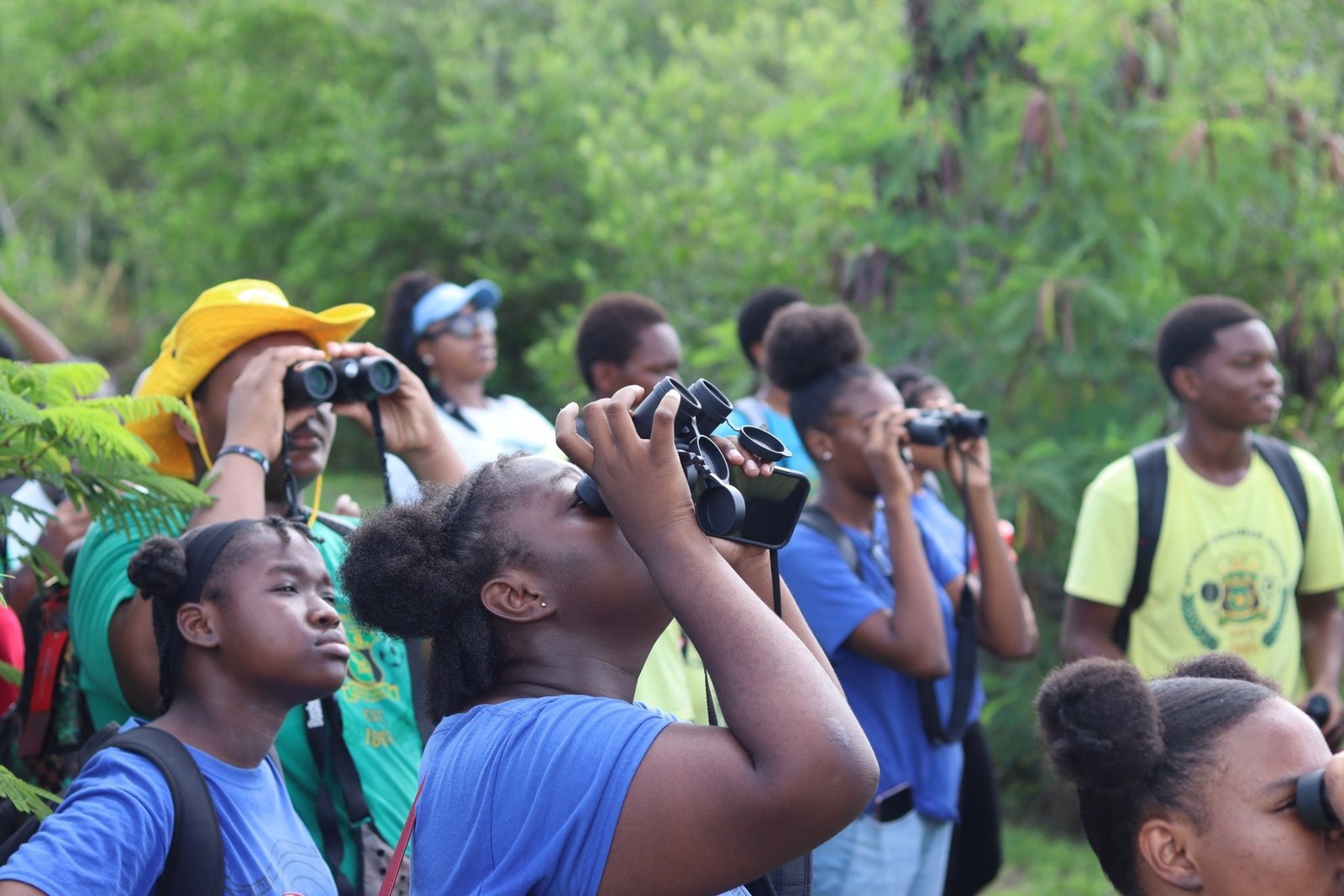 Young participants exploring the environment with binoculars.